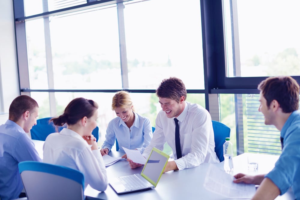 Group of happy young  business people in a meeting at office